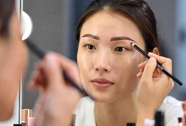 Asian women using eyebrow pencils - Visual for China New Cosmetic Ingredient Filing